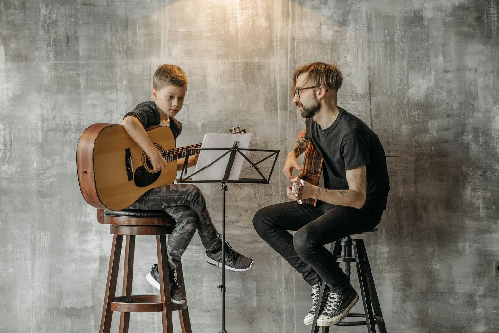 a boy playing an acoustic guitar